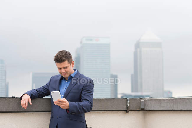 Empresário olhando para smartphone — Fotografia de Stock