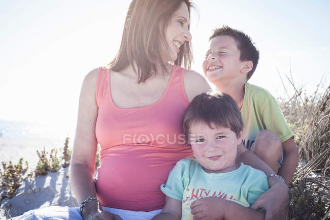 Mother and sons on beach — Stock Photo