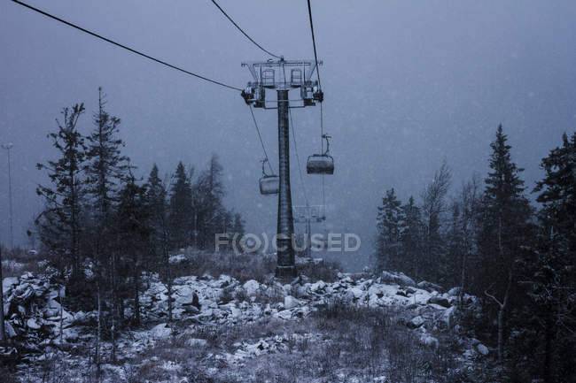 Chairlift during mountain snowstorm — Stock Photo