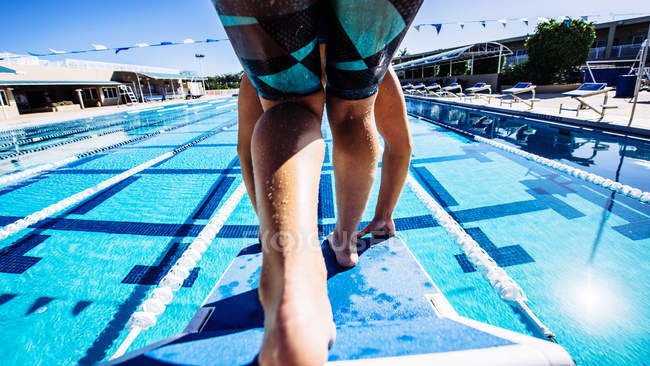 Swimmer on pool diving board — Stock Photo