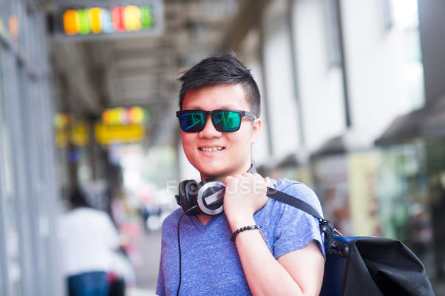 Man with headphone wearing sunglasses — Stock Photo