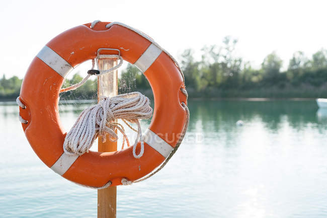 Lifesaver ring on beside lake — Stock Photo