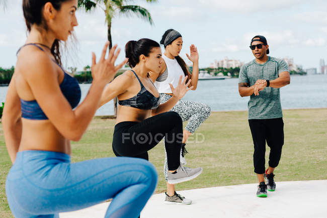 Women working out with trainer — Stock Photo