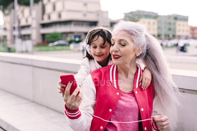 Mulher e menina ouvindo música — Fotografia de Stock