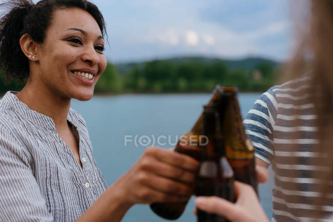 Amigos sosteniendo botellas de cerveza - foto de stock