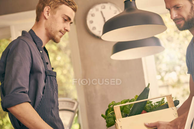 Chef receiving delivery — Stock Photo