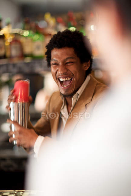 Camarero mezclando bebidas en el bar - foto de stock