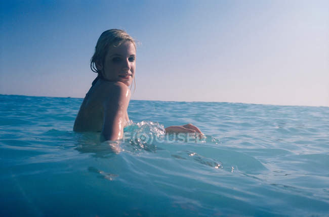 Woman sitting in water — Stock Photo