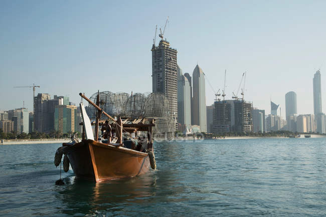 Boat and Abu Dhabi skyline — Stock Photo