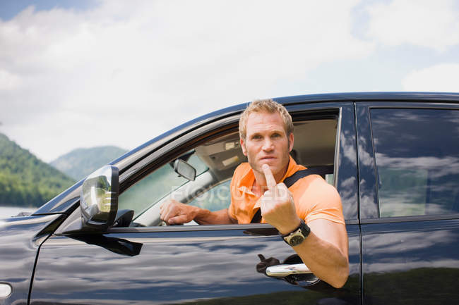 Angry man in a black car — Stock Photo
