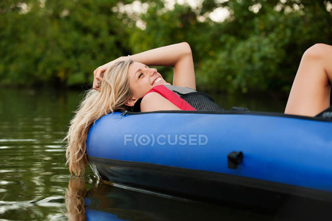 Woman relaxing in kayak — Stock Photo