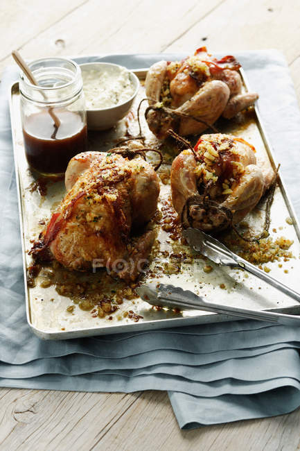Tray of roasted stuffed chickens — Stock Photo