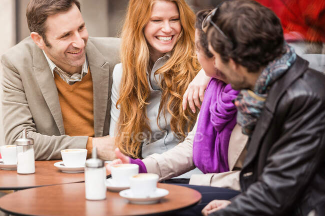 Пары пьют кофе в кафе на тротуаре — стоковое фото