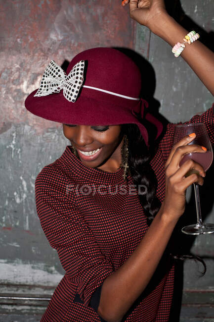 Woman in hat drinking at party — Stock Photo