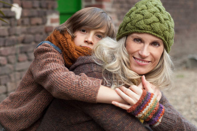 Boy embracing smiling mother — Stock Photo