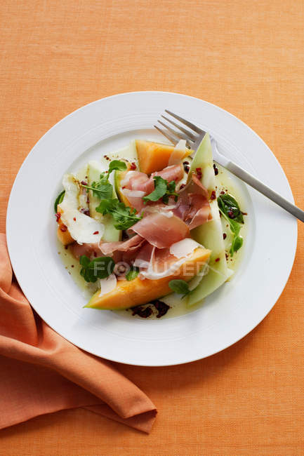Salad with melon, cheese and ham — Stock Photo
