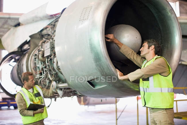 Aircraft workers checking airplane — togetherness, teamwork - Stock ...