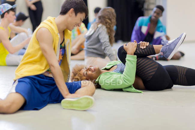 Dancers stretching together in studio — Stock Photo