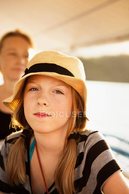 Girl wearing straw hat outdoors — Stock Photo