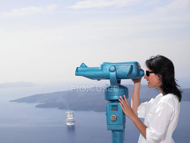 Woman looking through spyglasses — Stock Photo