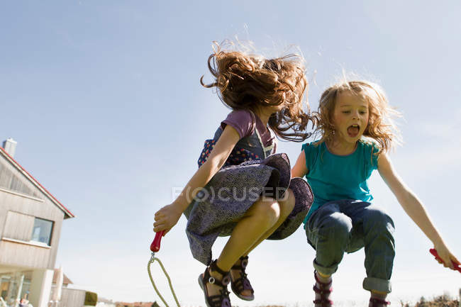Дівчата стрибають мотузкою разом на відкритому повітрі — стокове фото
