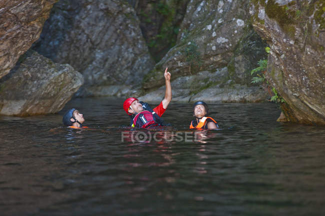 Men and woman swimming in water in canyon — Stock Photo