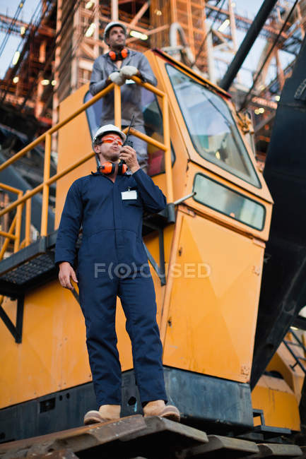 Worker using walkie talkie on site — Stock Photo