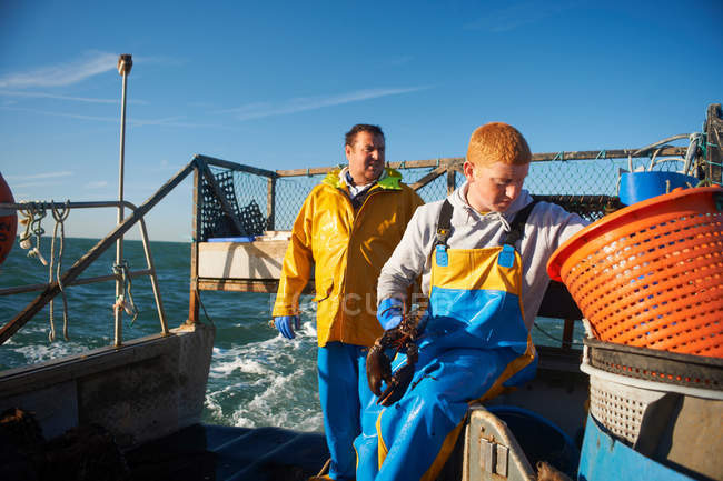 Fishermen at work on boat — Stock Photo