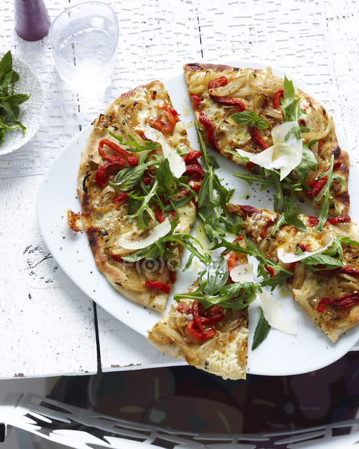 Plate of sliced wholemeal pizza — Stock Photo