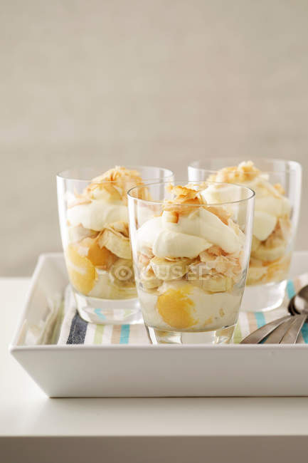 Parfait with banana and toasted coconut — Stock Photo