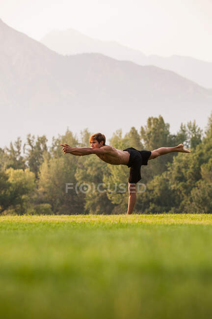 Hombre practicando yoga en el parque - foto de stock