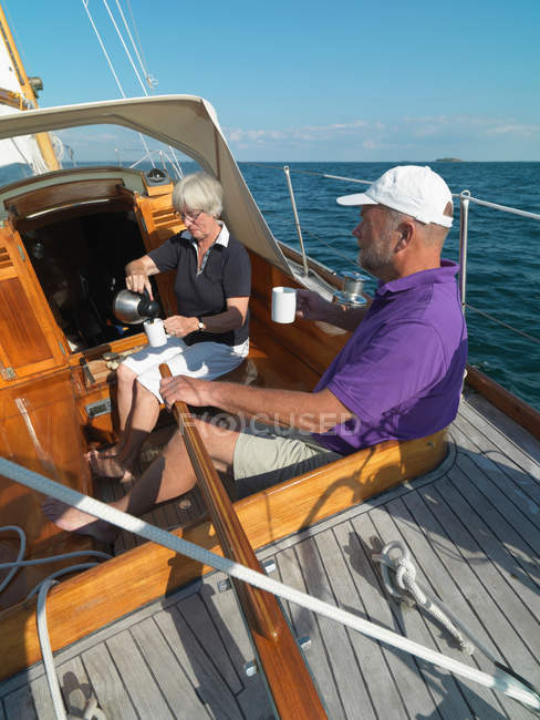 Older couple sailing together on ocean — Stock Photo