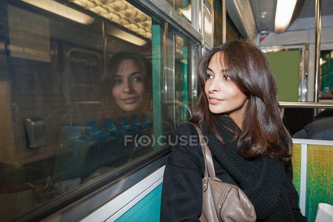 Smiling woman riding subway — Stock Photo