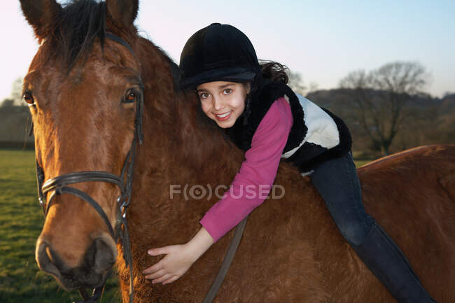 Ragazza abbracciando il suo pony — Foto stock