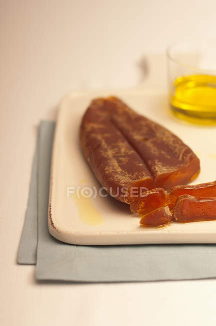 Bottarga with oil on tray — Stock Photo