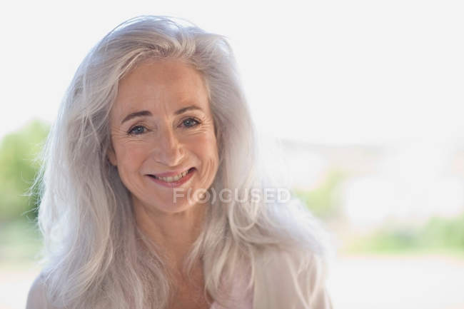 Older woman smiling outdoors — Stock Photo