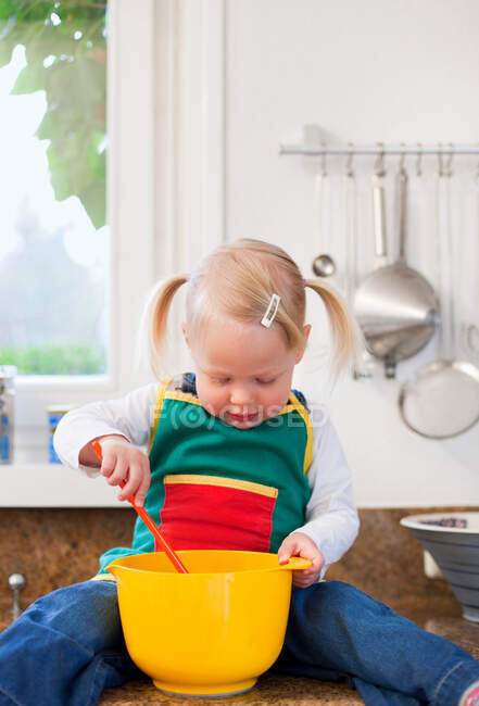 Toddler girl mixing ingredients — Stock Photo