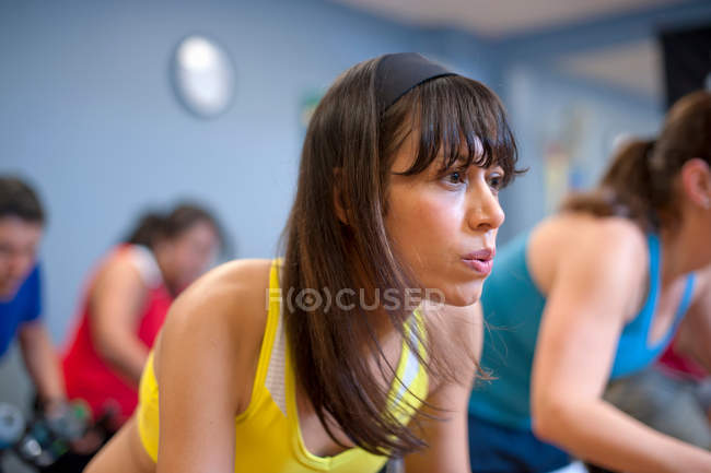 People using spin machines in gym — Stock Photo