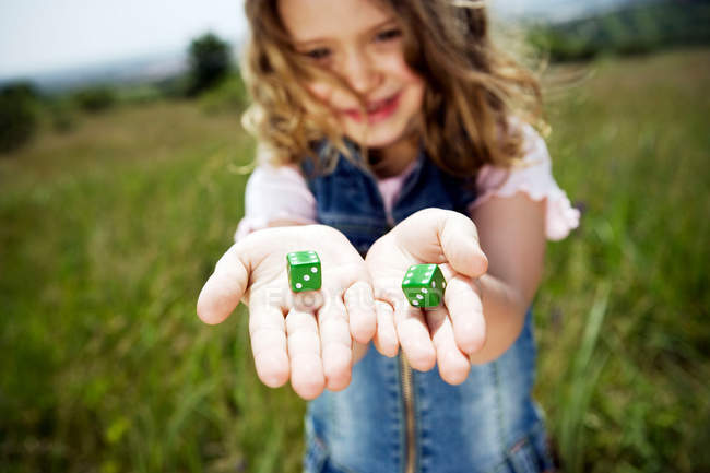 Portrait of girl holding dices — Stock Photo