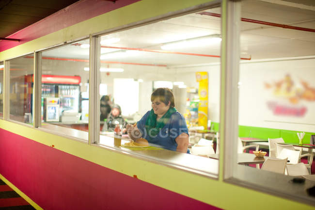 View of young woman in cafe window — Stock Photo