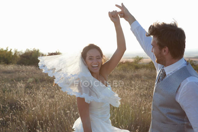 Newlywed couple dancing outdoors — Stock Photo