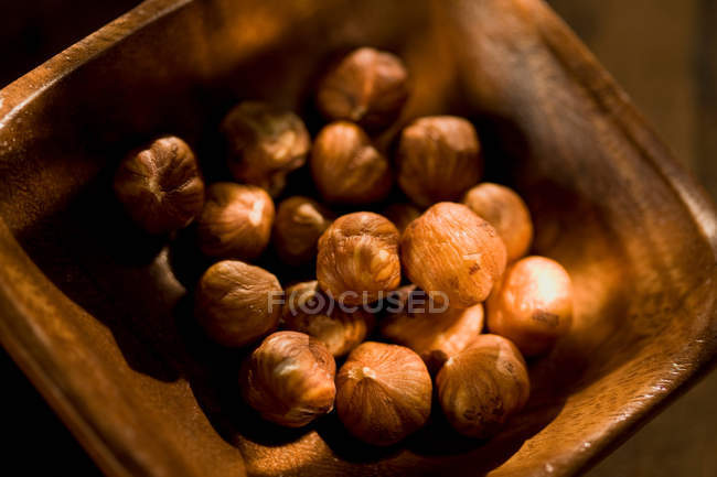 Shelled hazelnuts in bowl — Stock Photo