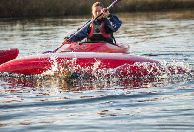 Mid adult woman kayaking — Stock Photo