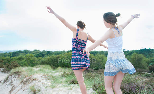 Women playing airplanes on beach, selective focus — Stock Photo
