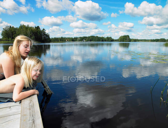 Woman and girl on a dock — Stock Photo