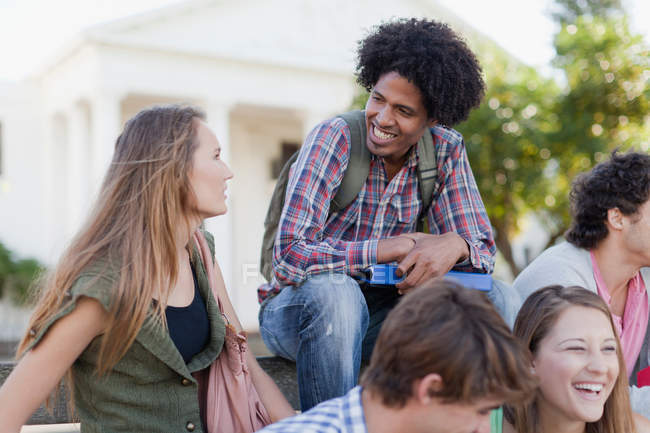 Students talking on campus, focus on foreground — Stock Photo