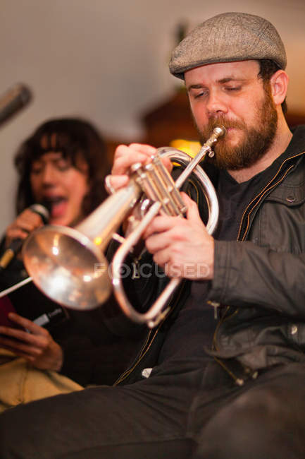 Trumpet player practicing with band — Stock Photo