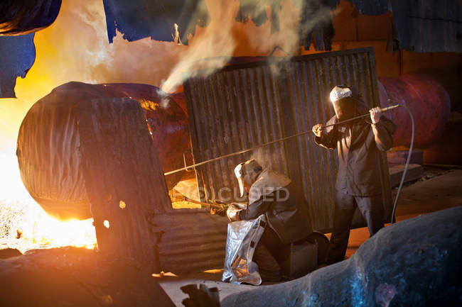 Welders at work in steel forge — Stock Photo