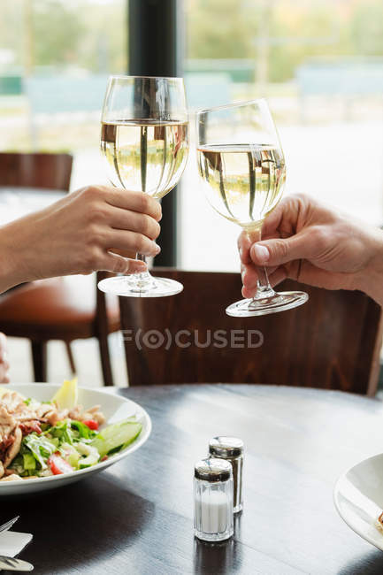 Couple hands toasting at cafe — Stock Photo