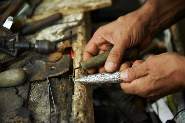 Male hands carving metal — Stock Photo